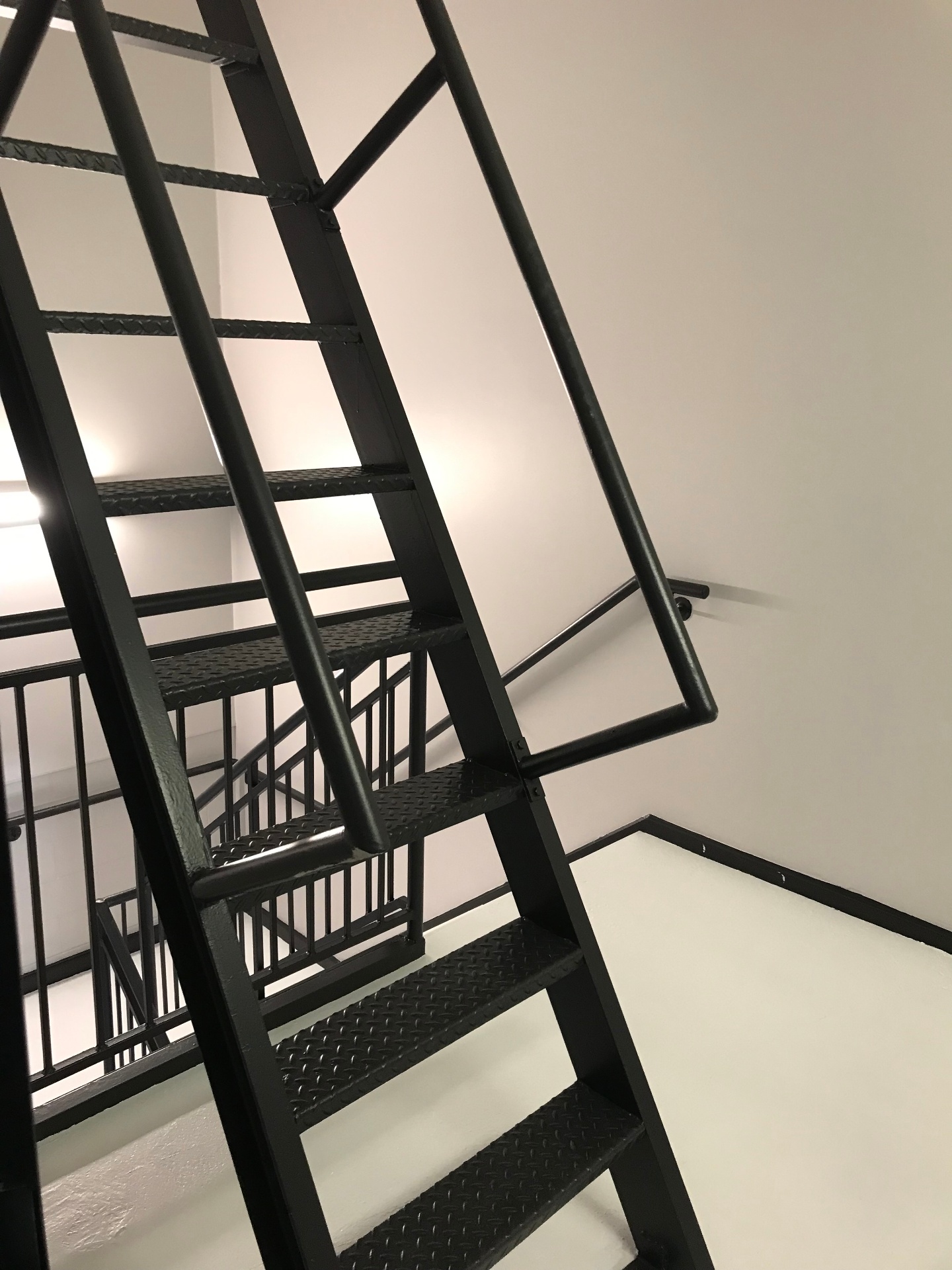 Completed commercial stairwell with professional black metal finish