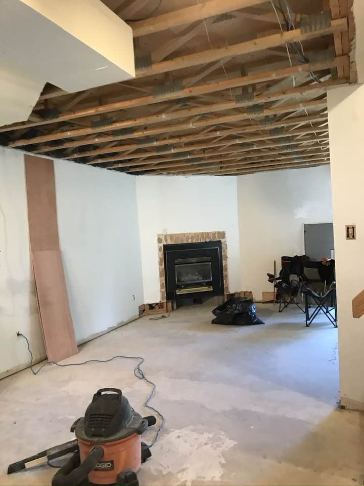 Condo interior before painting showing exposed ceiling joists and construction