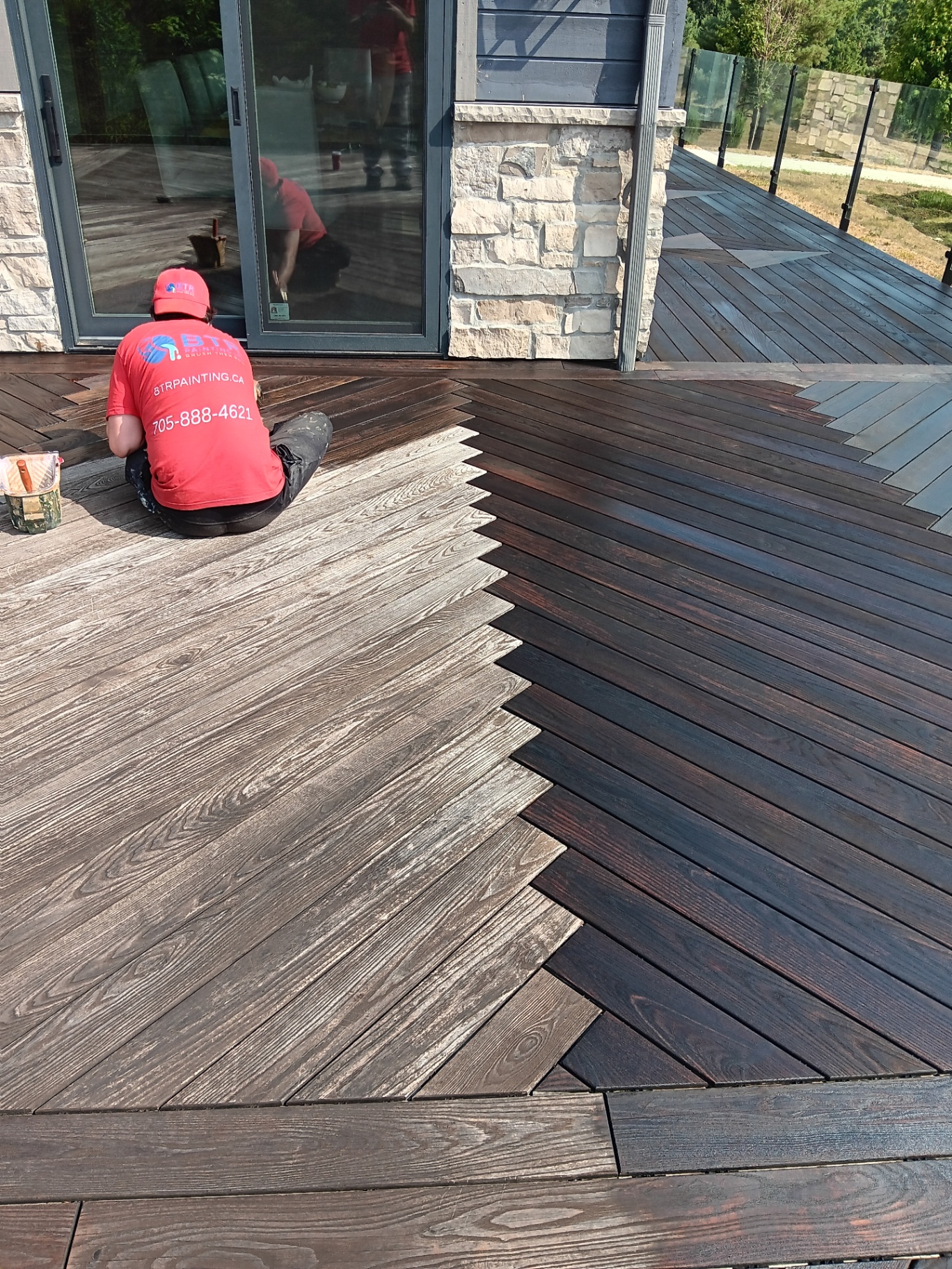 Professional deck staining in progress - BTR Painting team applying premium stain