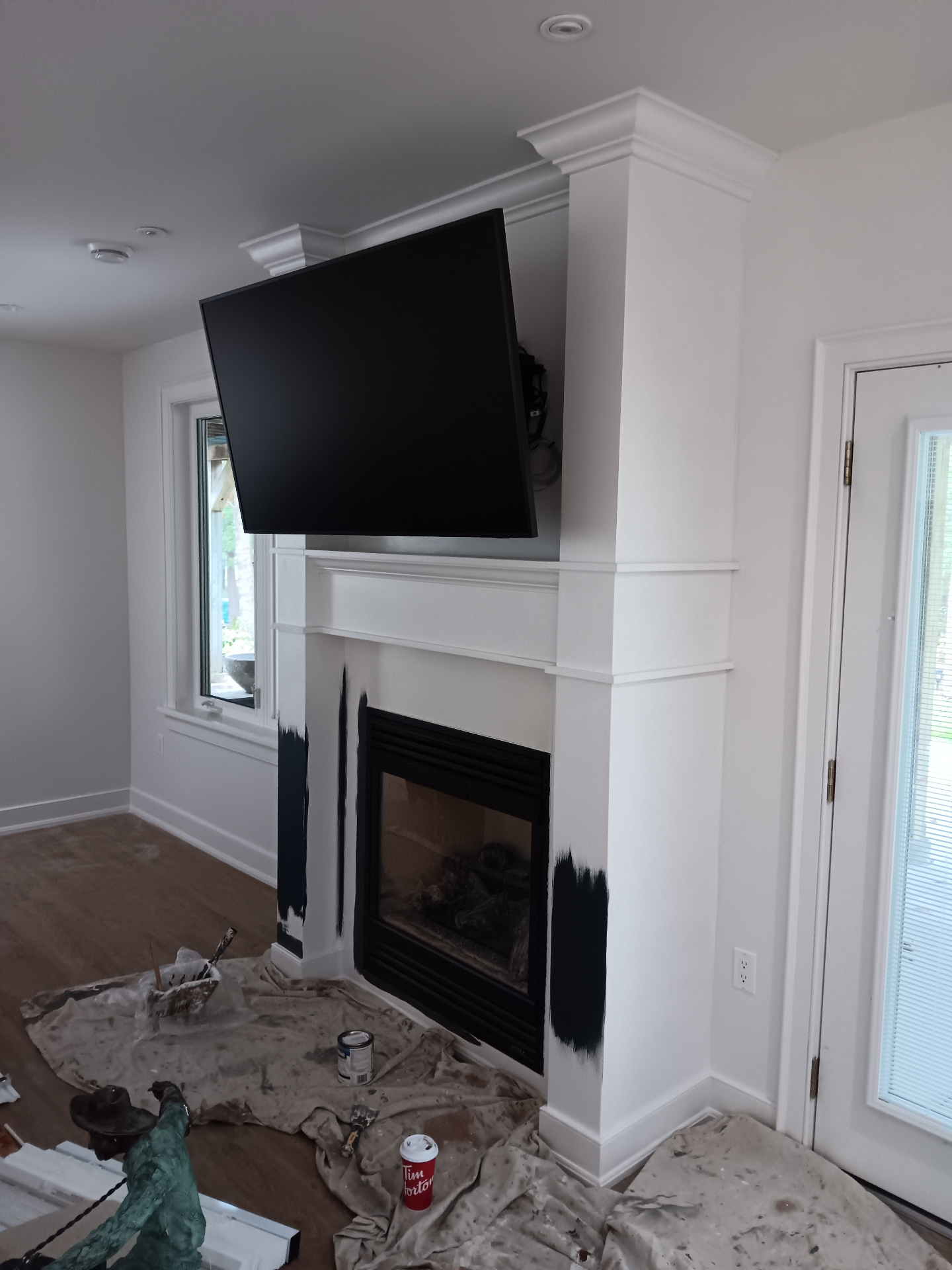 Freshly painted white fireplace with built-in shelving and professional finish