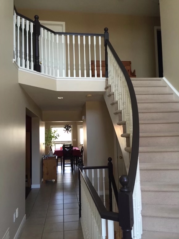 After interior painting: updated staircase with white spindles and dark rails