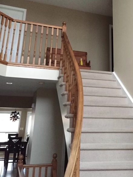 Before interior painting: natural wood staircase and railings in Collingwood home